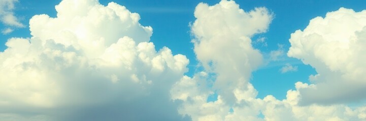 Fototapeta premium White fluffy clouds scattered across a vibrant blue sky on a sunny summer day, clouds, fluffy