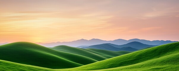 Obraz premium Lush green hills stretch under a vibrant sunset, creating a serene and picturesque landscape of nature's beauty.