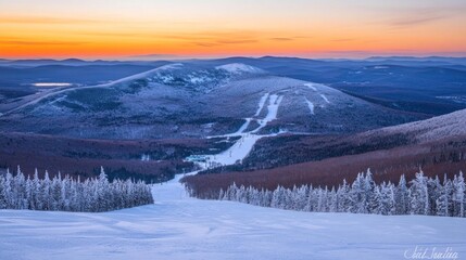 Sunrise over snowy mountain ski resort.