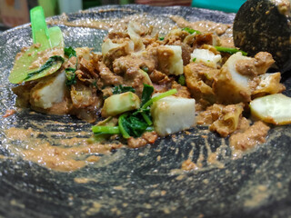 Rujak Cingur. Traditional Javanese food consisting of lontong with vegetables, peanut sauce, petis, tempeh, tofu, beef tongue, and crackers.