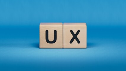 Businesswoman made word ux with wood building blocks.close up of wooden elements,Business Concept.3D rendering on blue background.