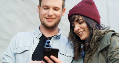 Couple, phone and happy with travel in city with notification, reading and check booking for taxi on sidewalk. Man, woman and smartphone on mobile app, smile and search for direction on trip in Spain