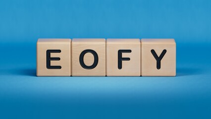 eofy word on wooden cubes.close up of wooden elements,Business Concept.3D rendering on blue background.