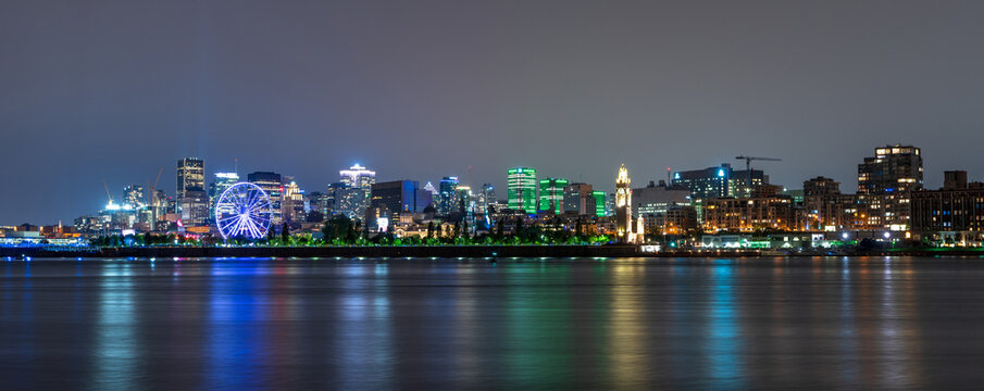View of downtown Montreal city skyline and Saint Lawrence River at night, Quebec, Canada.