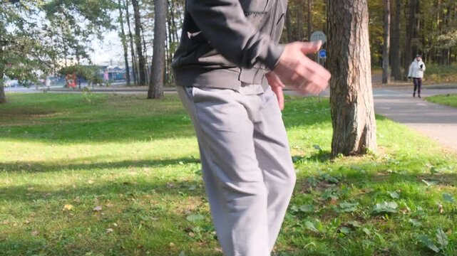 An athlete jumps on a tree stump in the park