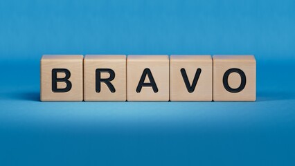 The word bravo appearing wooden cubes. Education concept.close up of wooden elements,Business Concept.3D rendering on blue background.