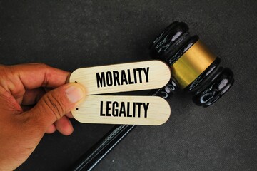 judge's hammer and the words morality and legality. What are the two principles of natural law?...