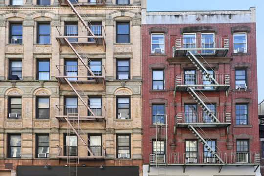 New York City, old apartment building with external fire ladder and ornamental carvings around windows