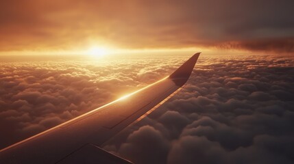Obraz premium Golden Hour Flight: A breathtaking aerial view of a sunset over a sea of clouds, as seen from an airplane wing.