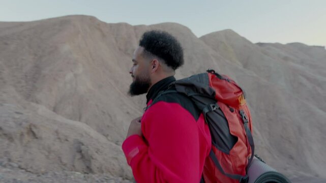 A passionate hiker revels in the stunning landscapes of Death Valley, experiencing the vibrant colors of fall while backpacking through its unique and diverse terrains with immense joy