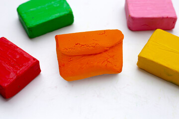 Colorful plasticine clay on white background.