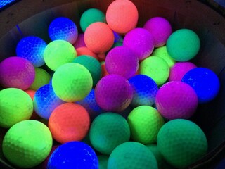 Vibrant Neon Golf Balls in a Basket