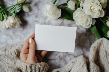 Hand holding a white blank card mockup