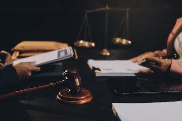 Judge gavel with Justice lawyers having team meeting at law firm background. Concepts of Law and Legal services.