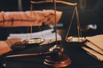 Judge gavel with Justice lawyers having team meeting at law firm background. Concepts of Law and...