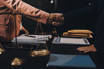 Judge gavel with Justice lawyers having team meeting at law firm background. Concepts of Law and Legal services.