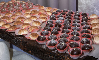 A table full of assorted desserts, including chocolate covered pastries