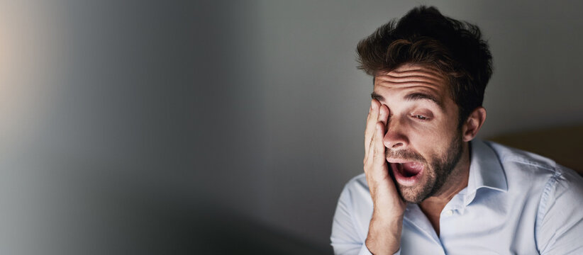 Business, tired and man with yawn in office for deadline fatigue, overworked and low energy on mockup space. Banner, night trader and exhausted of stock market investment, burnout or working overtime