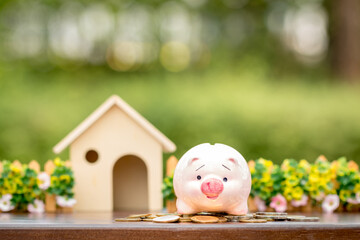Home model put and the piggy bank with grow value up with working capital management put on the gold coin in the public park, Loan and business investment for buy real estate concept.