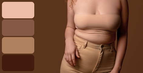 Beautiful young body positive woman in stylish jeans on brown background, closeup