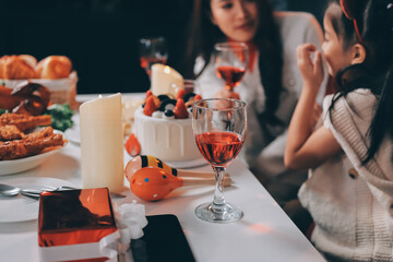 Multi-Generation Family Celebrate Christmas At Home Wearing Santa Hats And Antlers Opening Presents
