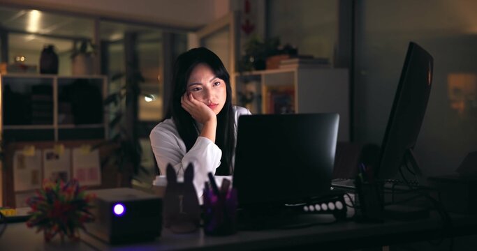 Tired, asian woman or night with laptop for design, project deadline or fatigue at office. Female person, employee or designer working late with computer for overworked strain or burnout at workplace