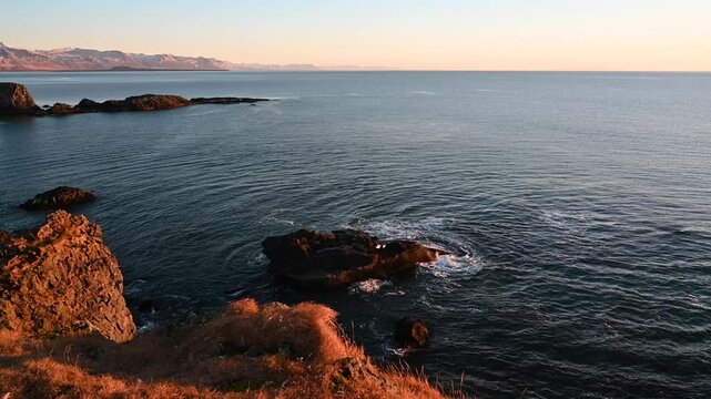 Panoramic view of the ocean with sunrise scene on Arnarstapi, Iceland