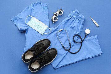 Medical supplies with shoes and optical trial frame on blue background. Top view