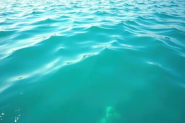Obraz premium Gentle turquoise waves on a calm water surface with ripples in the distance, mirror-like, natural beauty