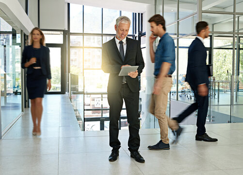 Business people, walking and man on tablet in office for productivity, synergy and coworking. Professional, corporate workers and mature person in busy workplace for movement, rush and hurry in lobby