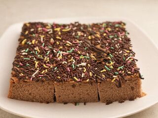 Chocolate sponge cake on white plate
