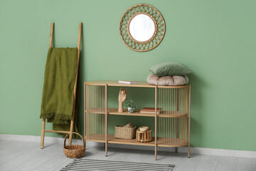 Stylish living room with shelving unit, mirror, plaid and ladder