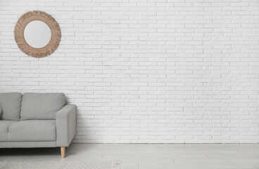Modern living room with grey sofa and mirror