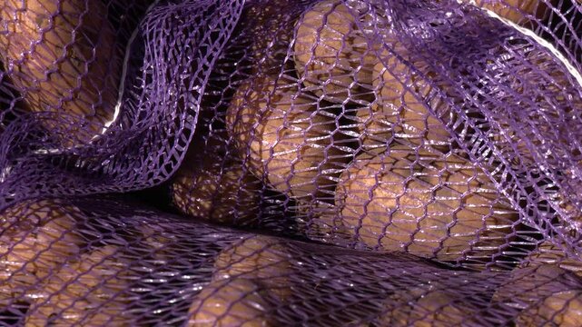 Sack of potatoes in warehouse waiting to be shipped to the market. Blue mesh bags with potatoes are stacked on top of each other. Close-up of potato tubers lying in a blue mesh bag. 
