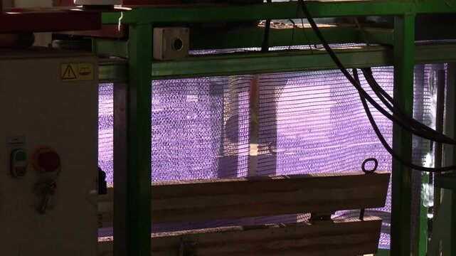 Packing potatoes into bags. Device for quick loading of vegetables into mesh bags. Sack of potatoes in warehouse waiting to be shipped to the market.
