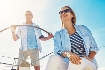 Sea, happy and couple on boat for anniversary, vacation or holiday with love or adventure in...