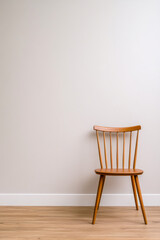 Simple wooden chair against a neutral wall in a minimalistic interior space