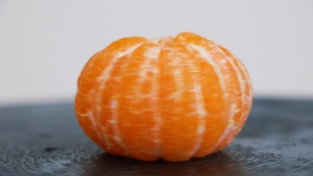 peeled ripe sweet tangerine, mandarin fruit without shell on a wooden blackboard