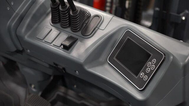 Detail of the interior of an old tractor in an industrial environment.close-up on the levers inside. Selective focus joystick for control excavator, installed in cockpit
