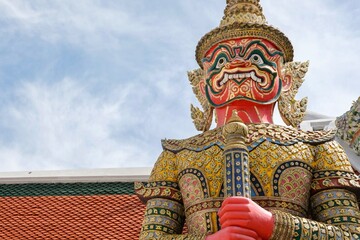 Close-up of Suriyaphop, a yaksha (giant) guardian statue with bamboo shoot crown at the Koei Sadat Gate of Wat Phra Kaew (Temple of the Emerald Buddha) inside the Grand Palace - Bangkok, Thailand