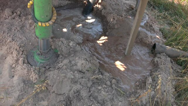 Excavation. Deep drilling. Water Well Drilling. Big drill for drilling a well. The water flowing artesian well from the land. Ground water well drilling.
