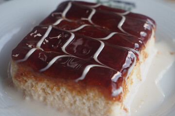 Delicious layered cake with fruit glaze and cream drizzle for dessert