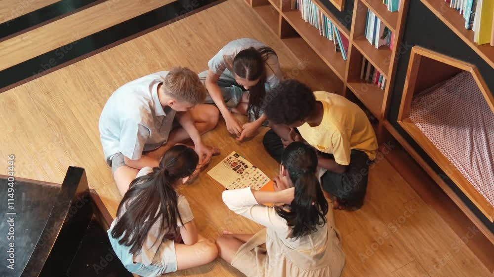 Poster group of diverse children sitting in circle while reading a book at library. top view of girl sharin