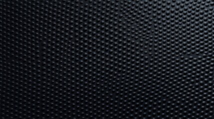 Dark black background with textured surface. Closeup view shows unique pattern of small round bumps. Material looks like rubber leather. Ideal for design projects as wallpaper for wall. Good for