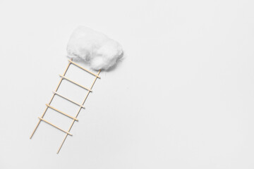 Ladder with cotton cloud on light background