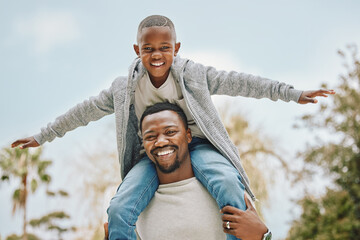 Happy, nature and black child on shoulders of father for playing, having fun and bonding together. Portrait, airplane and African dad carrying boy kid for connection at outdoor park in Nigeria.