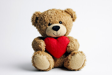 Obraz premium Teddy bear holding a red heart sitting against a plain white background. Minimalistic Valentine's Day and love concept. Design for greeting card, postcard, or banner