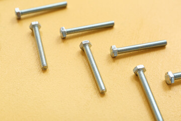 Tap bolts on yellow background