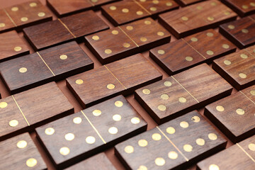 Many wooden dominos blocks on brown background