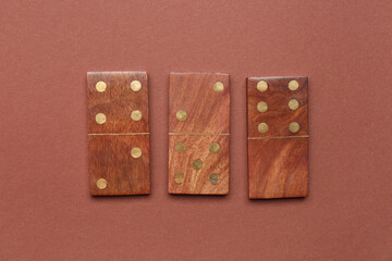 Wooden dominos blocks on brown background